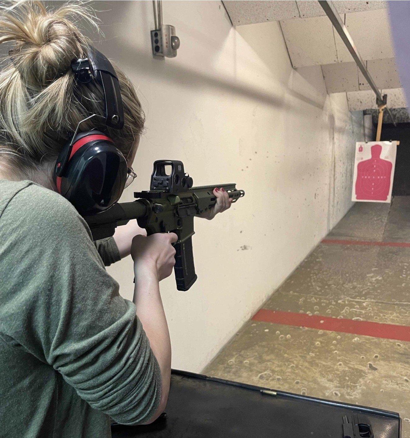 Rachel Fischer — Personal Protection Officer Training Rachel Fischer practicing at an indoor firing range during personal protection officer training